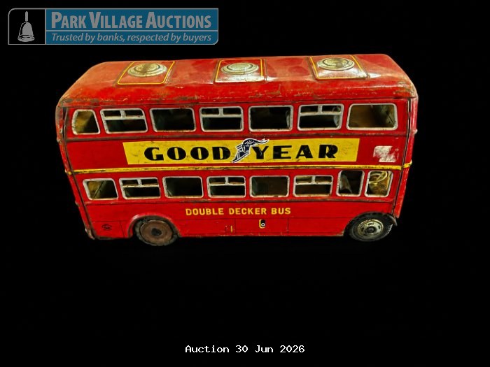 WEATHERED RED GOODYEAR DOUBLE-DECKER BUS MODEL WITH YELLOW SIGNAGE, WORN PAINT DETAILING AND VISIBLE INTERIOR,