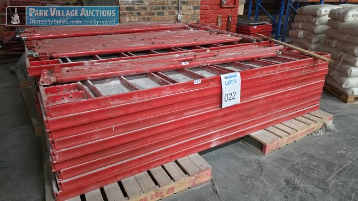 ASSORTED STACKED BUNDLES OF RED PAINTED HEAVY DUTY STEEL FORMWORK BEAMS